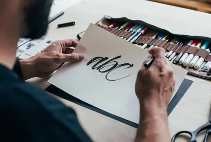 Designer hand-lettering a logo concept